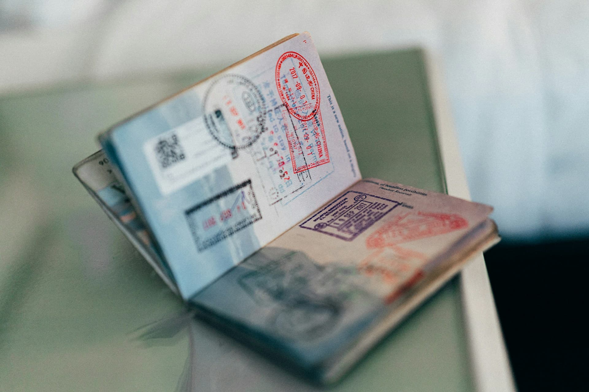 An open passport filled with entry and visa stamps
